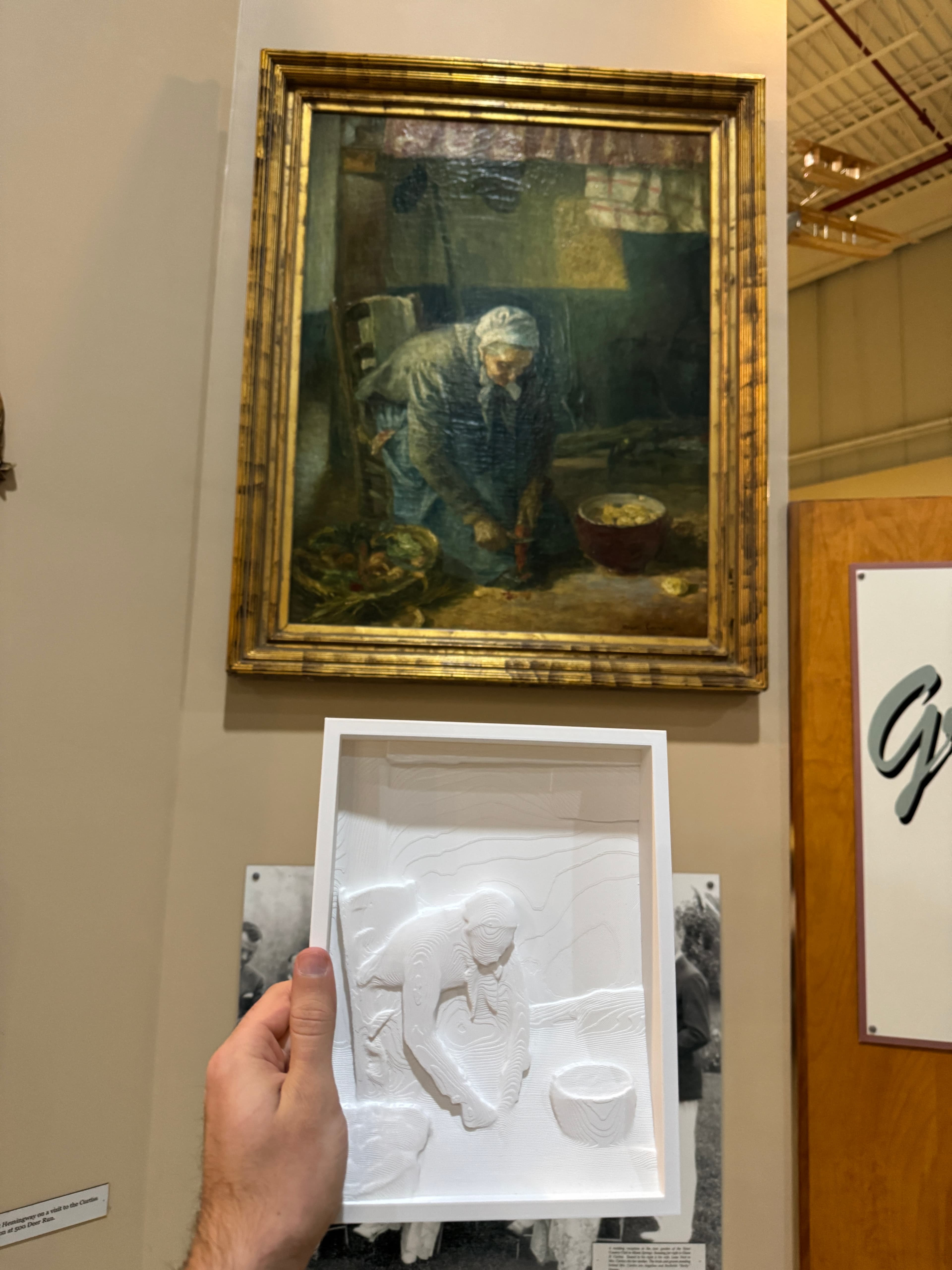 Farmlady Peeling Potatoes - tactile relief painting next to original artwork