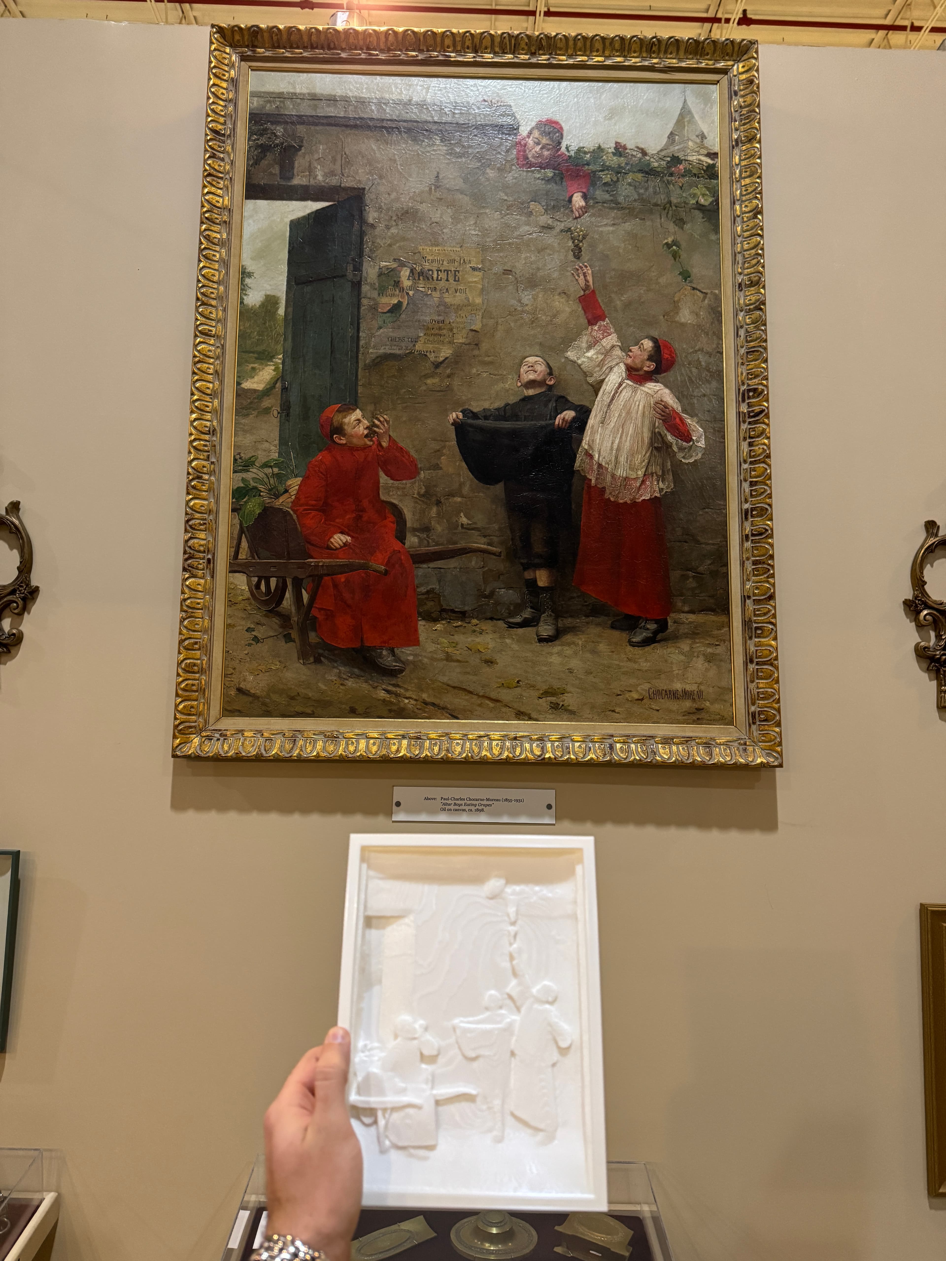 Altar Boys Eating Grapes - tactile relief painting next to original artwork